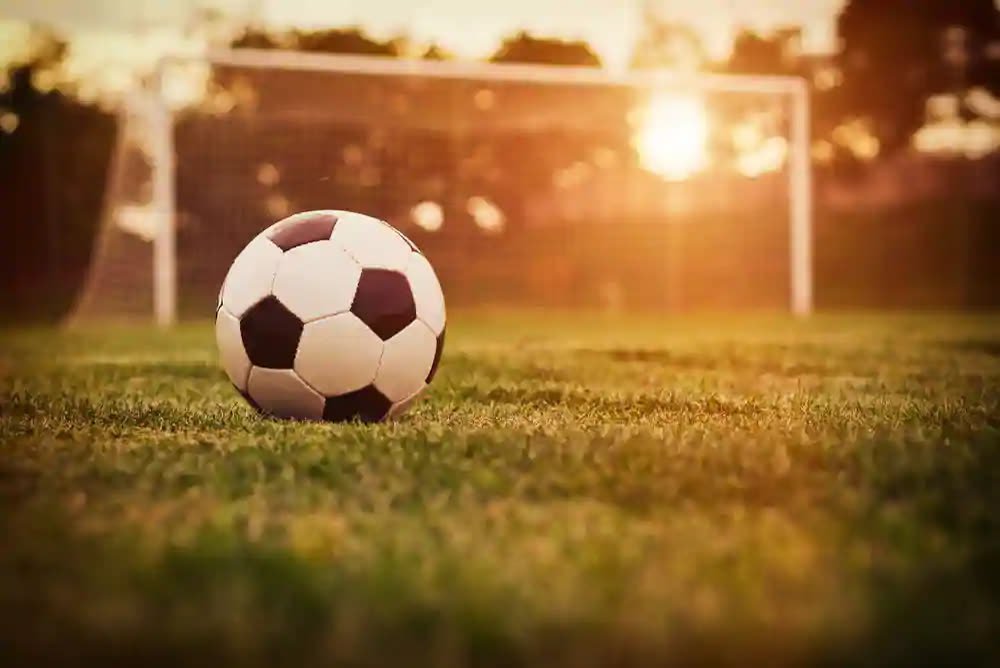Football on the open lawn at sunset